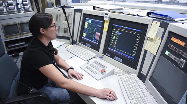 female student at the nuclear reactor control console.