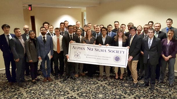 group shot of 18 students being inducted into alpha nu sigma